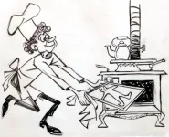 A baker placing cookies in the oven.